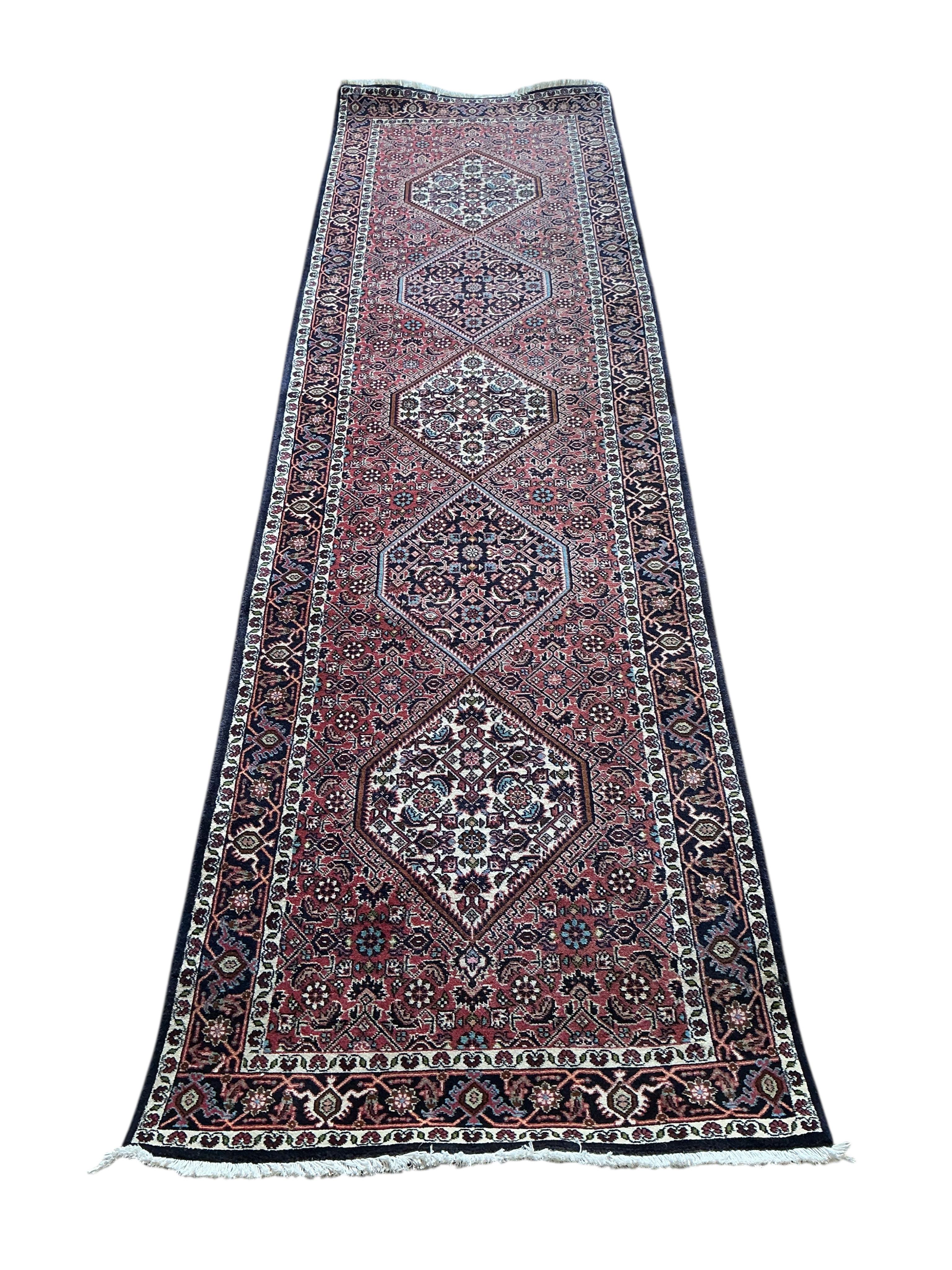 A Bijar red ground runner, approx. 295 x 83cm